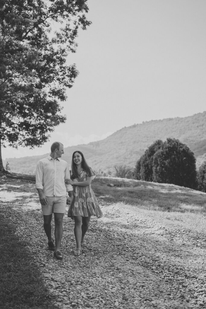 engaged couple walking for photos at yonah mountain