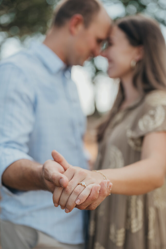 engagement photos couple showing ring and touching foreheads