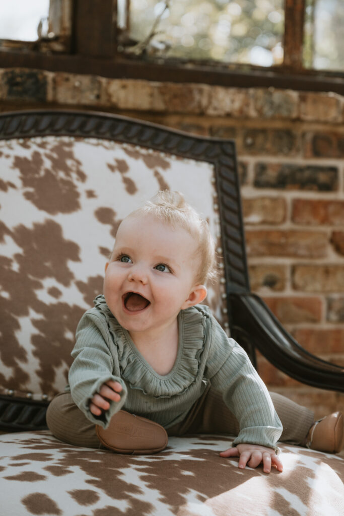 young child sitting in a cow print chair at sekrit theater in Austin Texas