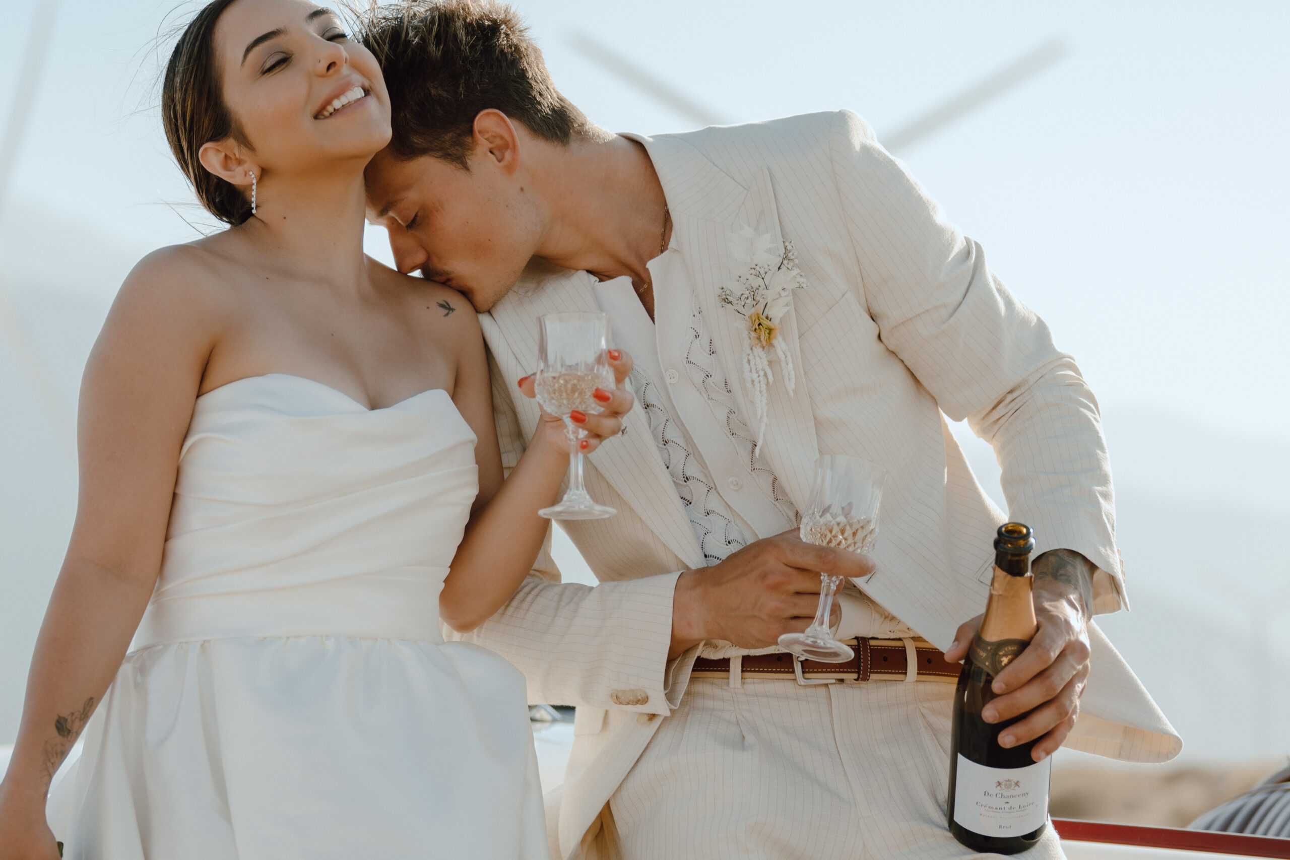 groom kisses the shoulder of his bride at their vintage elopement in Palm Springs california