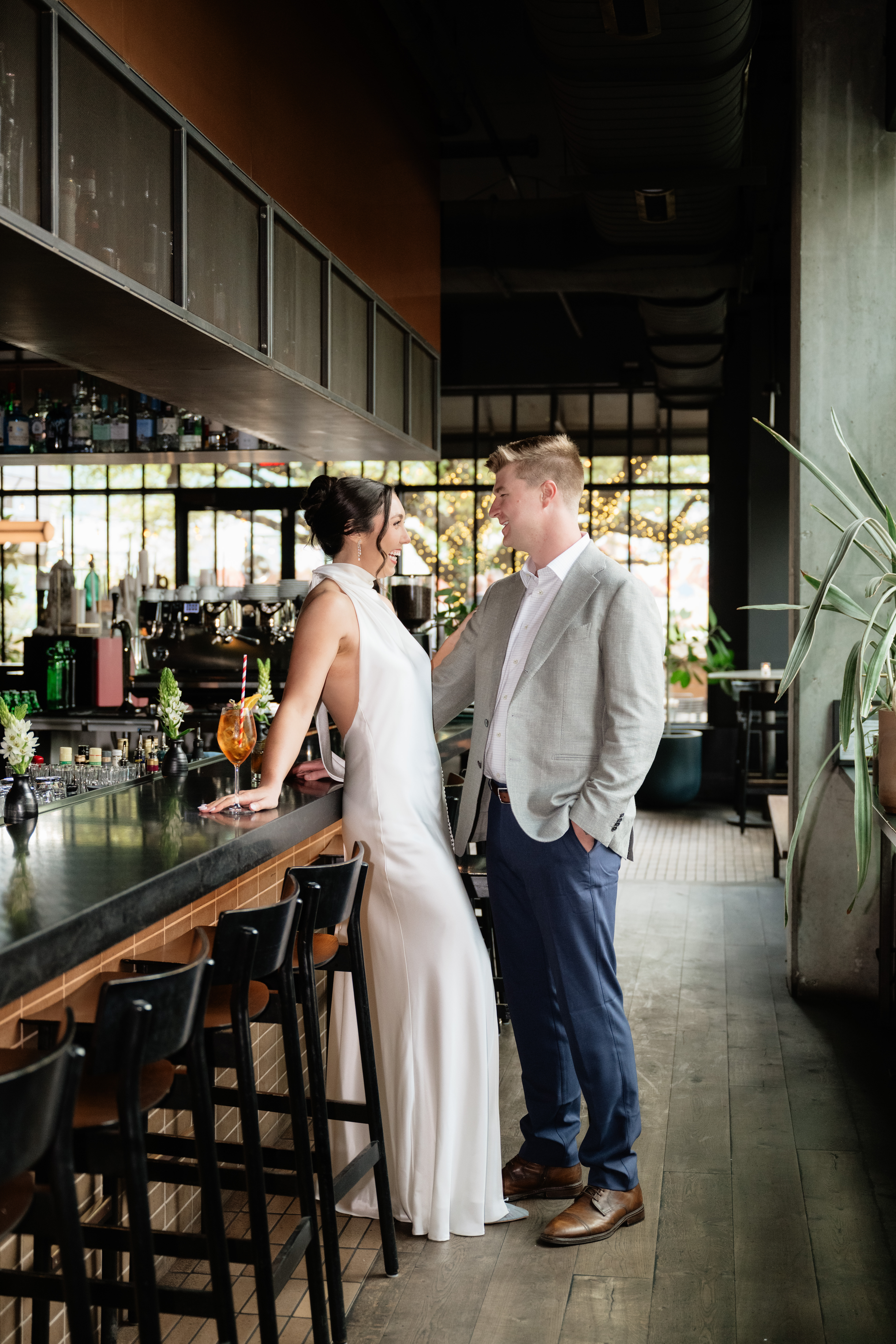 Bride and groom at the bar at Il Brutto Austin wedding rehearsal dinner and welcome party